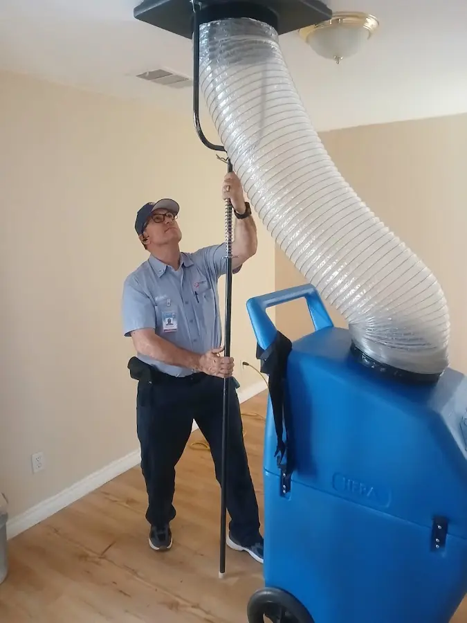 Furnace Tune-Up technician using HEPA equipment in Lithia Springs