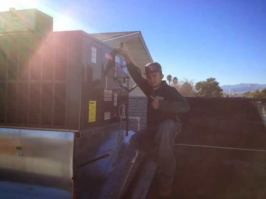 HVAC technician performing AC Tune-Up on a rooftop unit in Lithia Springs